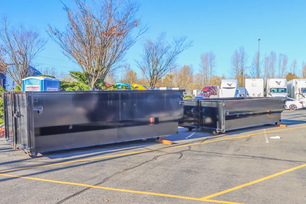 Professional dumpster rental service with roll-off container on residential driveway in Marblehead